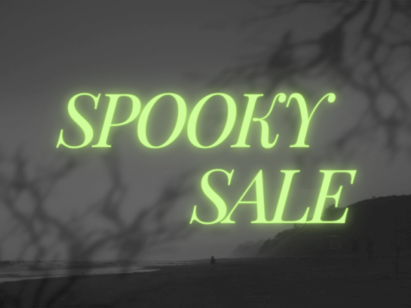 The image features the text "SPOOKY SALE" in glowing letters over a dark, eerie background with shadows of branches.